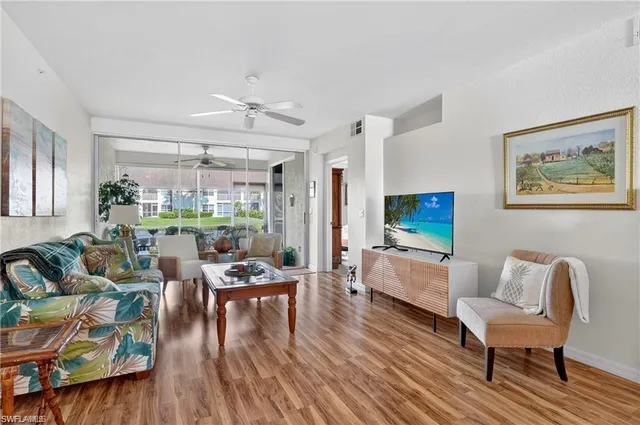 a living room with fireplace furniture and a large window