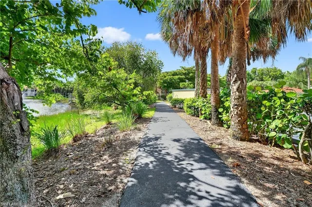 an aerial view of a residential houses with outdoor space and street view