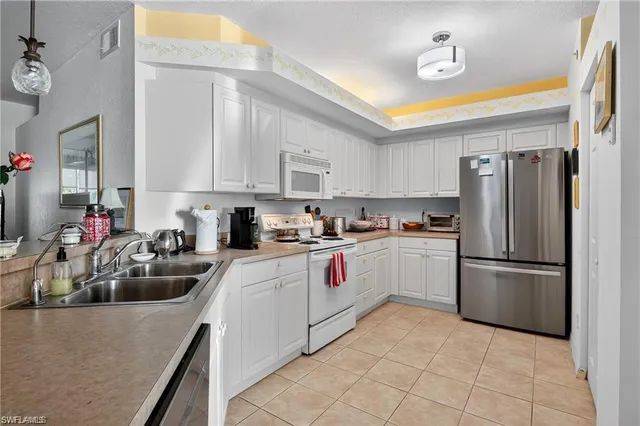 a kitchen with a sink appliances and cabinets