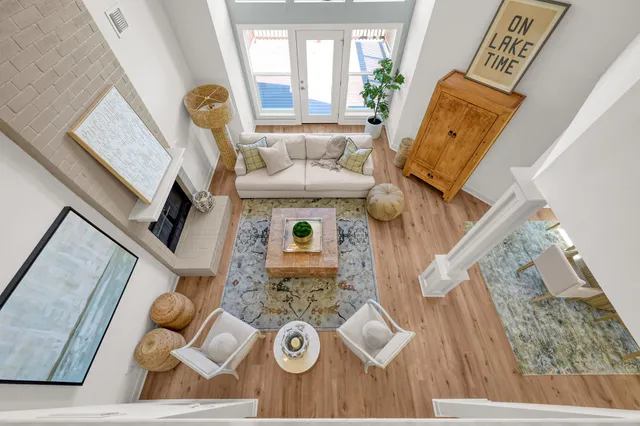 a living room with furniture and a floor to ceiling window