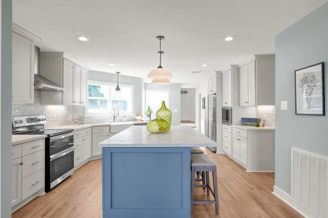 a kitchen with a stove a refrigerator and a sink