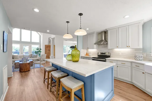 a kitchen with a table chairs stove and wooden floor