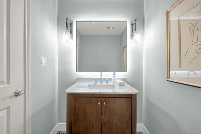 a bathroom with a sink and a mirror