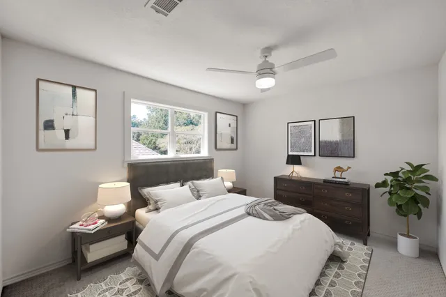 a bedroom with a large bed and a window