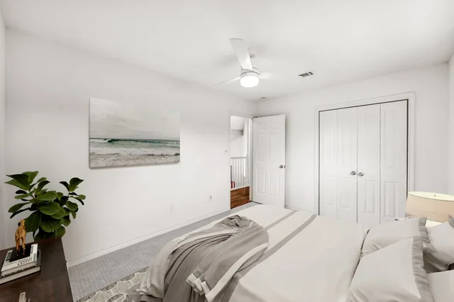 a bedroom with a bed and a potted plant