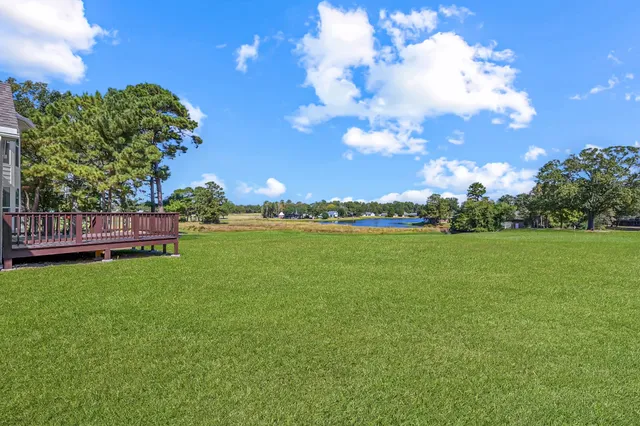a view of yard with swimming pool and green space