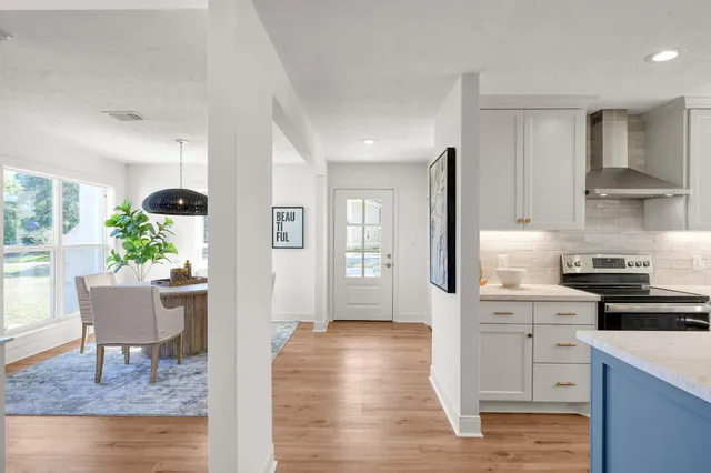 a kitchen with white cabinets and stainless steel appliances