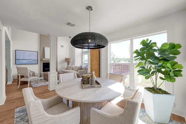 a living room with furniture potted plant and a chandelier