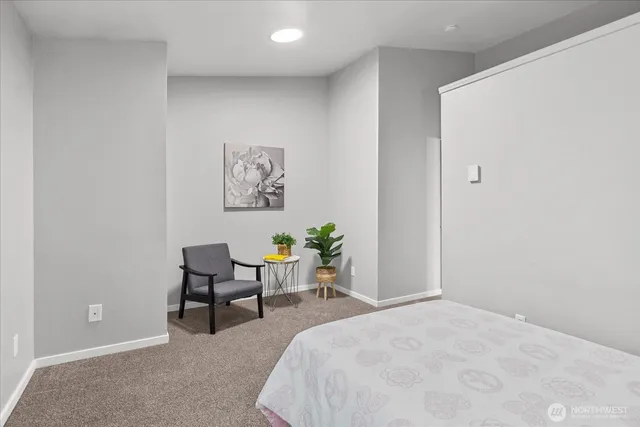 a bathroom with a granite countertop sink a toilet and a large mirror