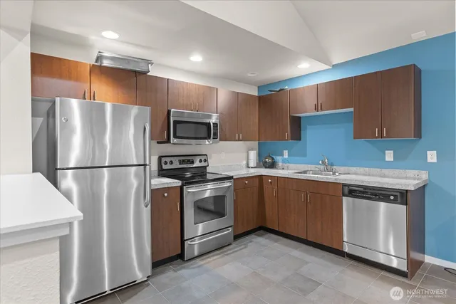 a view of a yard with plants and trees