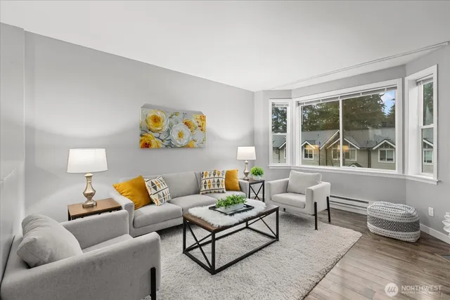 a living room with furniture and painting on the wall