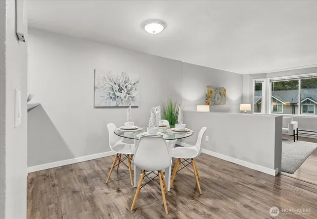 a view of a dining room with furniture and wooden floor