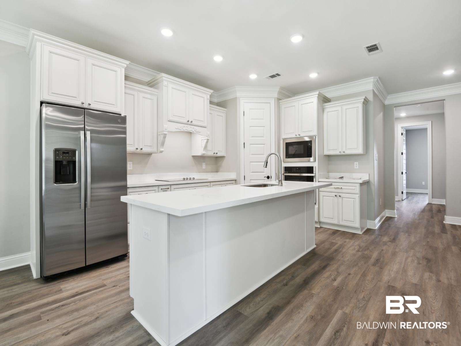 23937 Peppermint Street Elberta, AL 36530 - Photo 5 of 22 Kitchen with ornamental molding, stainless steel appliances, light countertops, white cabinets, and recessed lighting