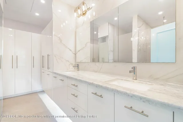 a bathroom with a sink double vanity and a mirror