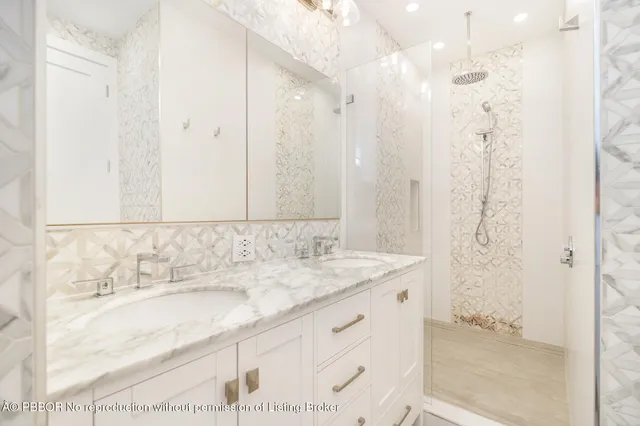a bathroom with a granite countertop sink a shower and a mirror
