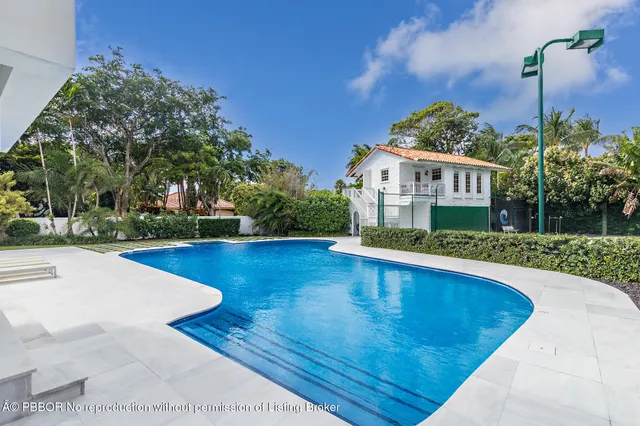 a view of a house with pool yard and a patio