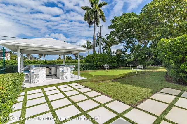 a view of a house with a backyard porch and sitting area