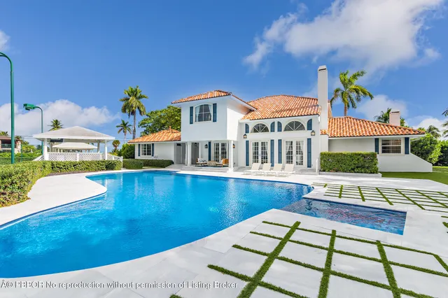 a view of a house with pool and chairs