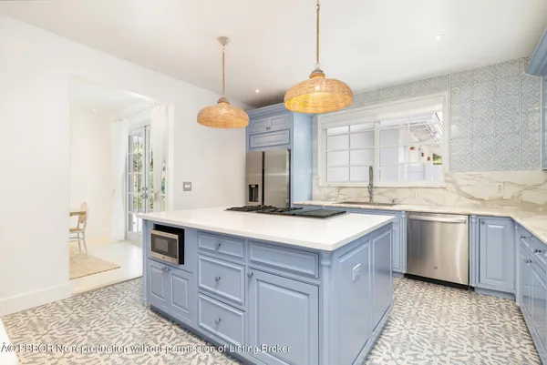 a kitchen with a stove and a wooden floor