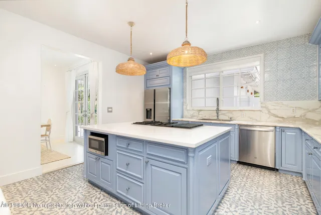 a kitchen with a stove and a wooden floor