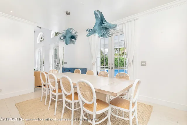 a view of a dining room with furniture and a chandelier