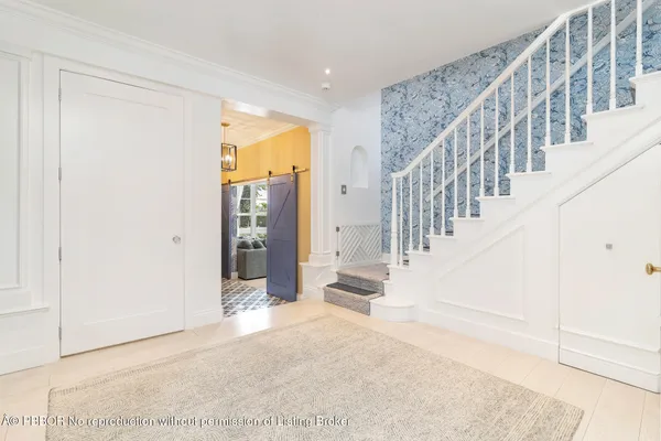 a view of entryway with wooden floor and stairs