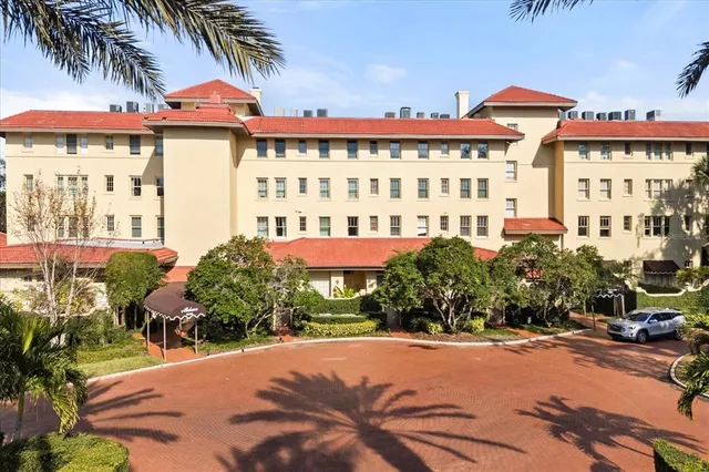 an aerial view of a city with lots of residential buildings ocean and mountain view in back