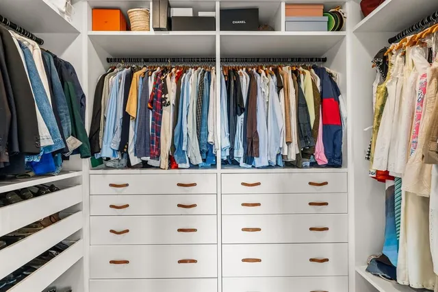 a living room with furniture kitchen view and a wooden floor
