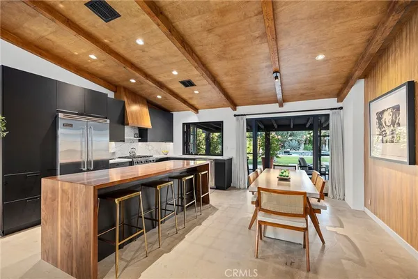 a kitchen with stainless steel appliances granite countertop a stove and a refrigerator
