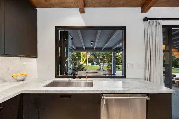 a kitchen with a sink and a large window