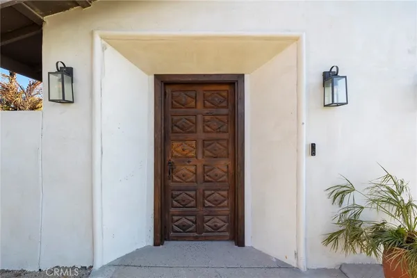 a entryway with a potted plant on a wall