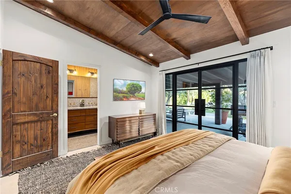 a bedroom with a large bed and a dresser
