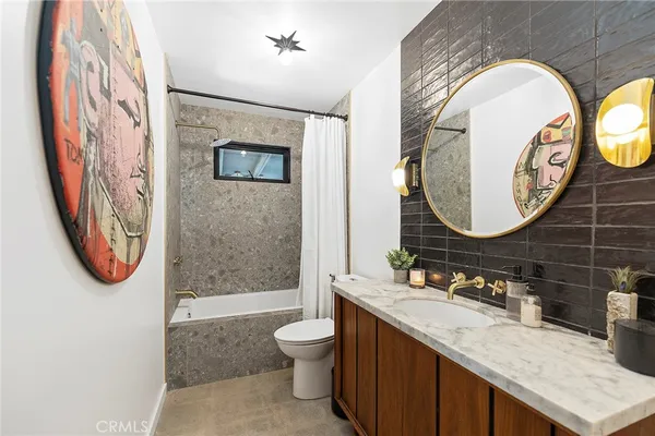 a bathroom with a toilet a sink and a mirror