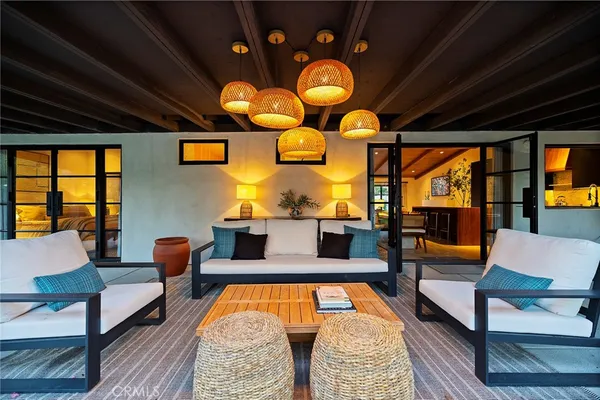 a living room with patio furniture and a large window