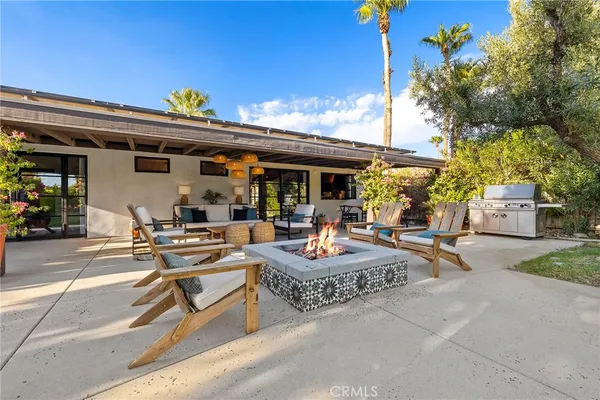 a view of the patio with dining table and chairs with plants
