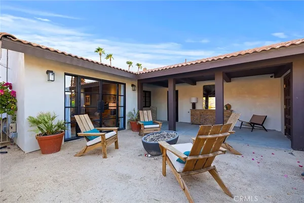 a view of a patio with table and chairs and potted plants