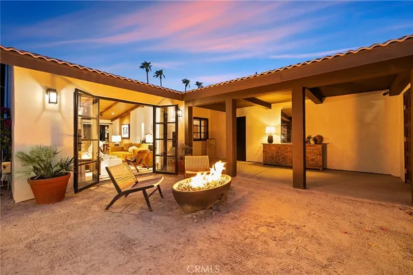 a living room with patio furniture and a potted plants