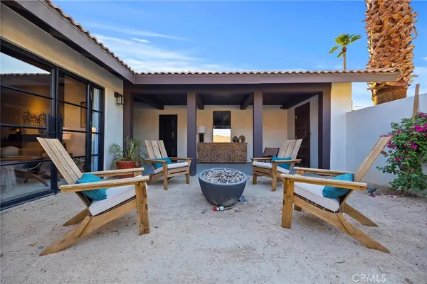 a view of a patio with a table and chairs