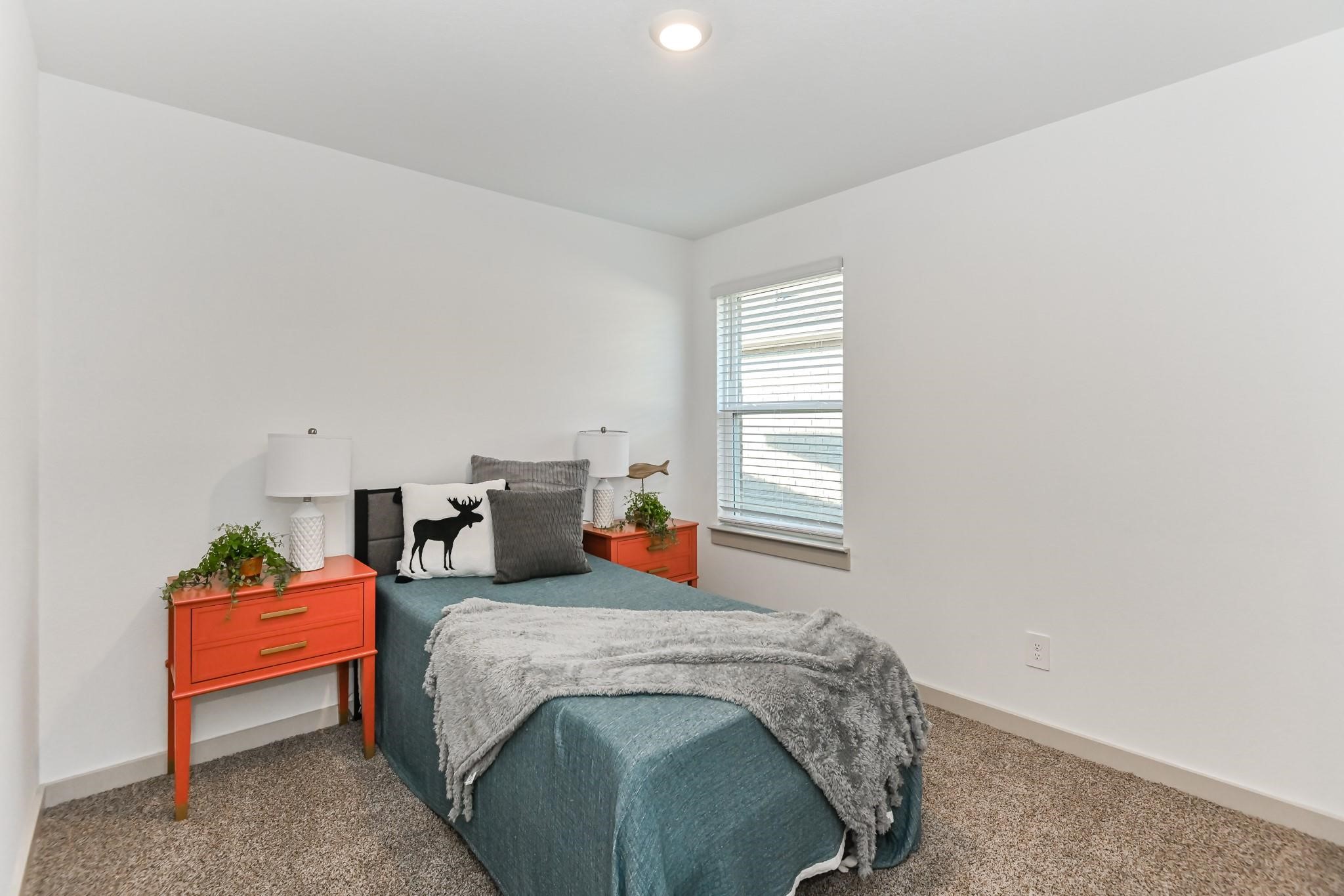7811 Golden Rubia Lane Rosharon, TX 77583 - Photo 10 of 10 This cozy bedroom. A window allows natural light to brighten the neutral walls and carpet.