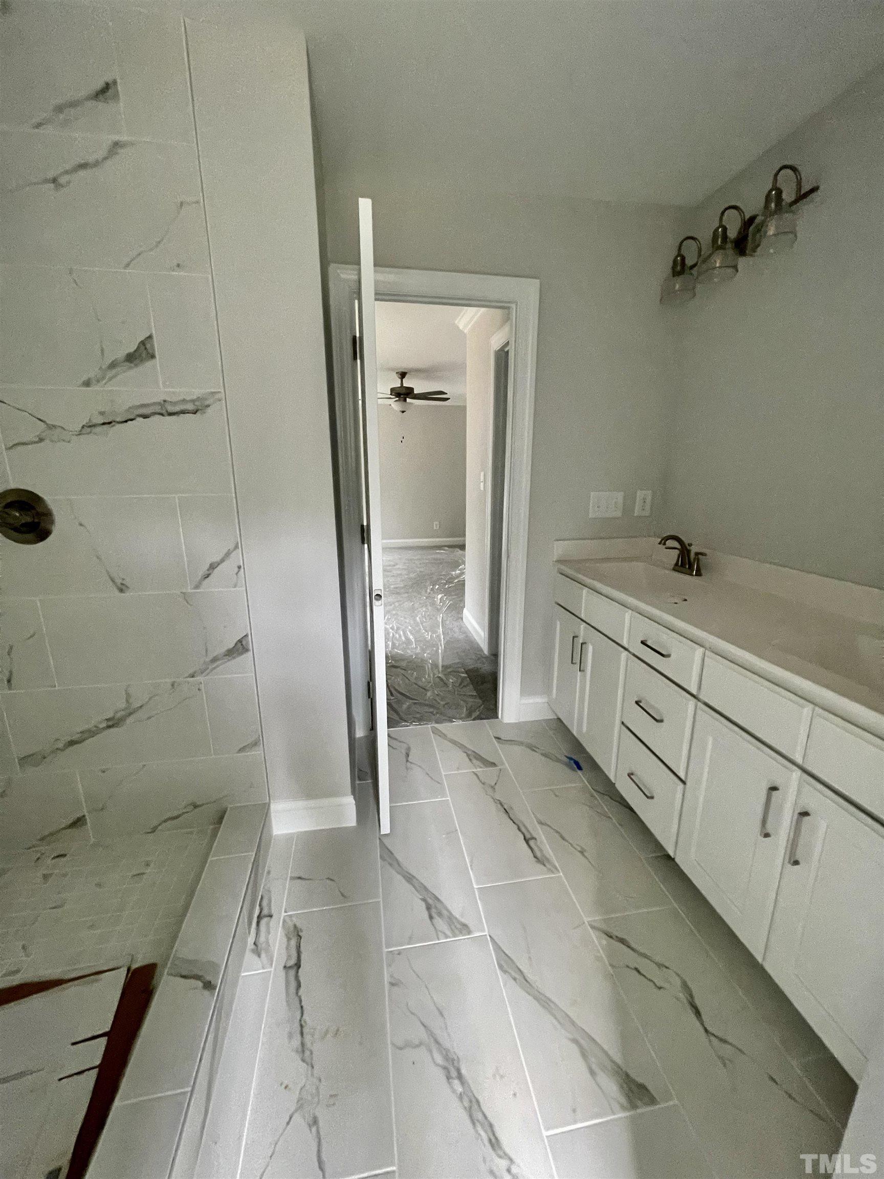 20 Mulberry Pl Spring Spring Hope, NC 27882 - Photo 13 of 18 a bathroom with a granite countertop sink a toilet and a shower