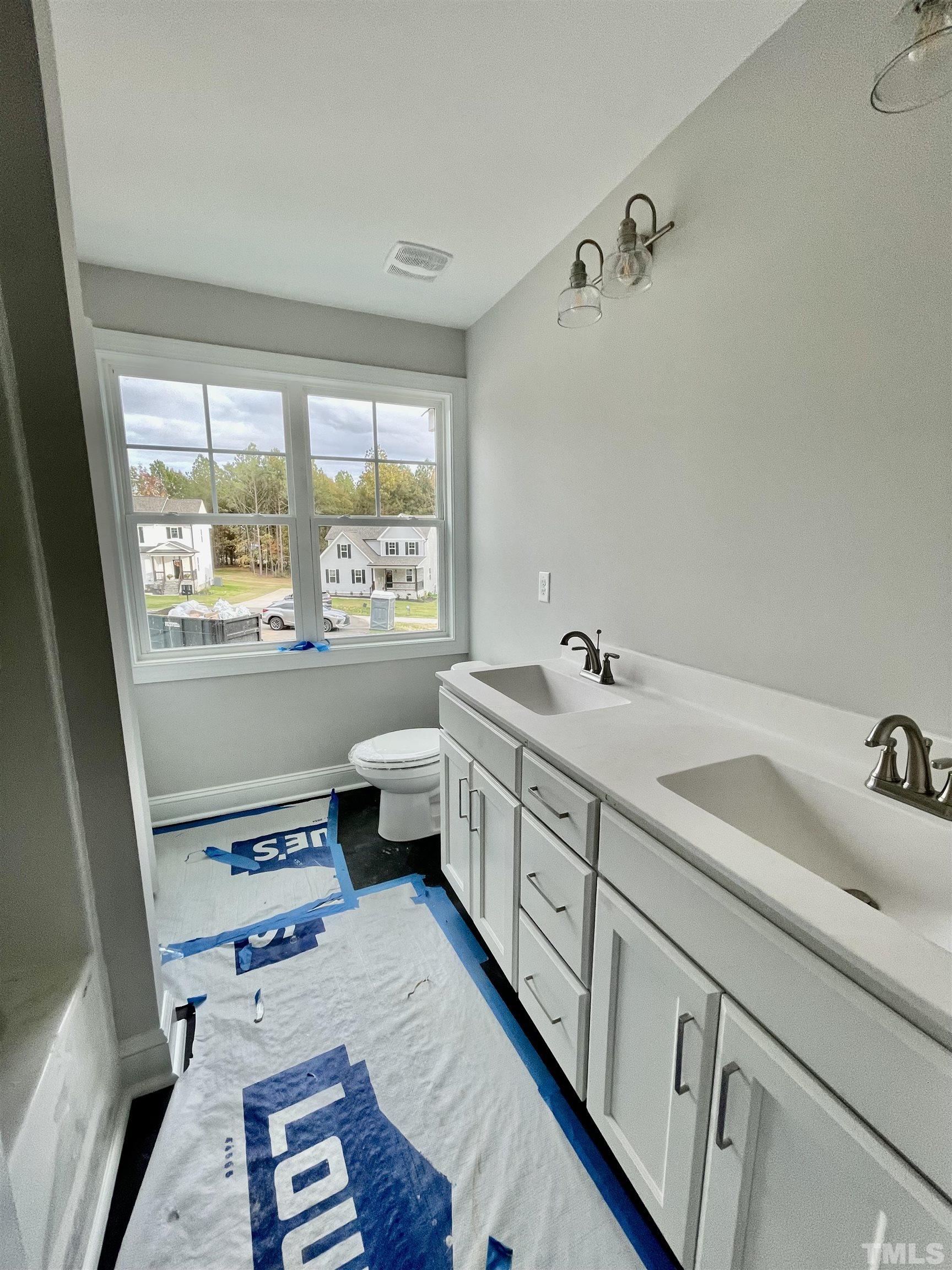 20 Mulberry Pl Spring Spring Hope, NC 27882 - Photo 16 of 18 a bathroom with a double vanity sink a mirror and a bathtub