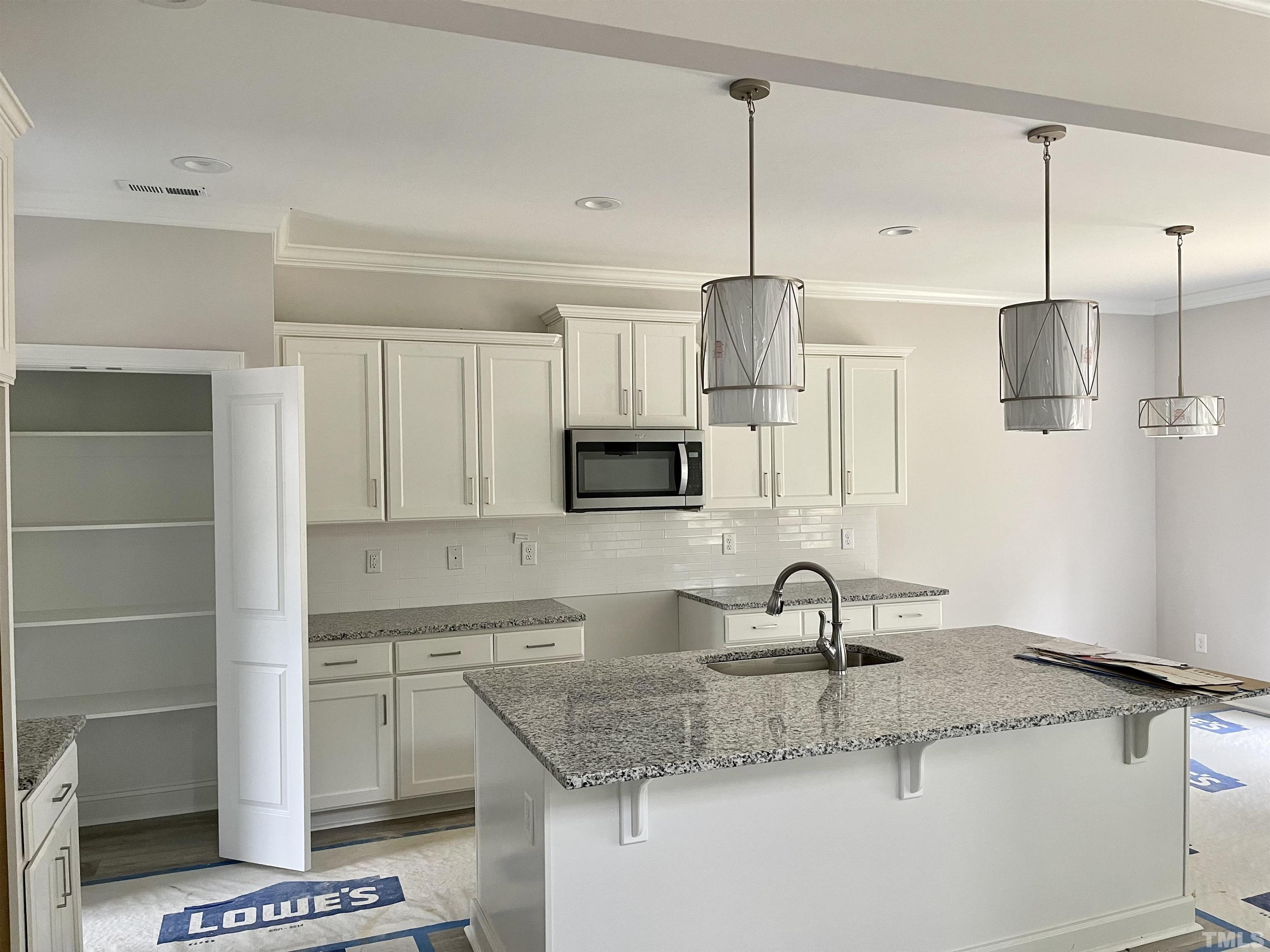 20 Mulberry Pl Spring Spring Hope, NC 27882 - Photo 6 of 18 a kitchen with stainless steel appliances granite countertop a sink a stove and a granite counter top