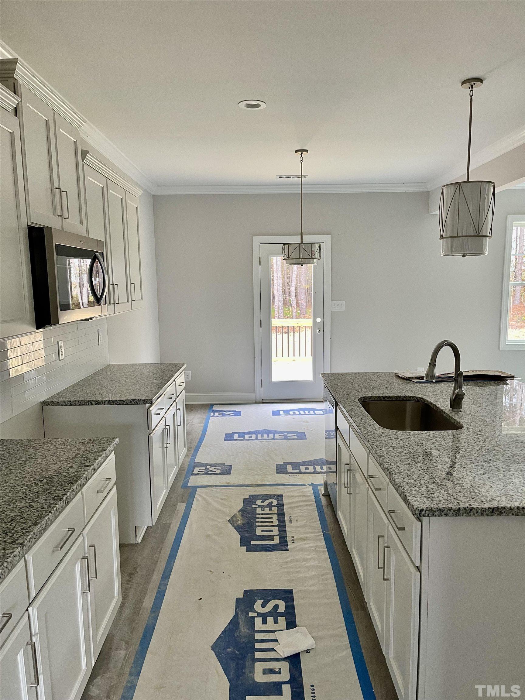 20 Mulberry Pl Spring Spring Hope, NC 27882 - Photo 8 of 18 a kitchen with granite countertop a sink stove and cabinets