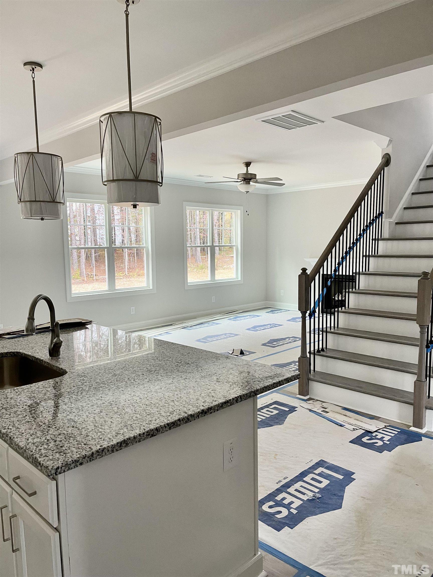 20 Mulberry Pl Spring Spring Hope, NC 27882 - Photo 9 of 18 a kitchen with kitchen island granite countertop a sink a counter space appliances and cabinets