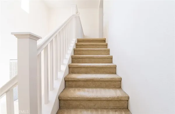 a view of staircase with white walls