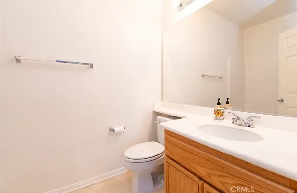 a bathroom with a sink a toilet and mirror