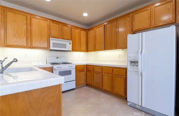 a kitchen with granite countertop cabinets stainless steel appliances and a sink