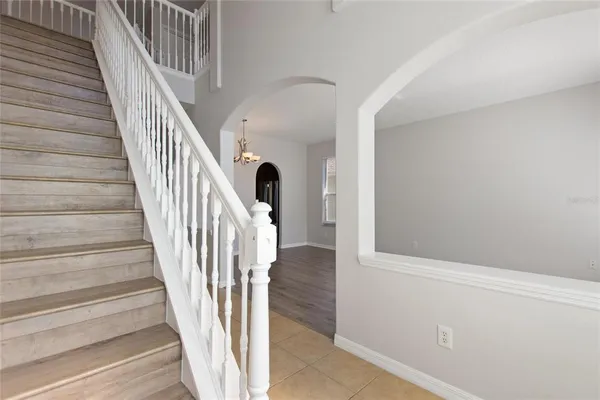 a view of staircase with wooden floor and white walls