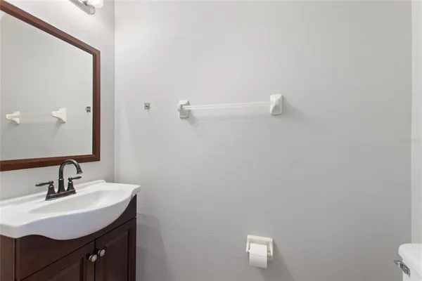 a bathroom with a sink vanity and a toilet