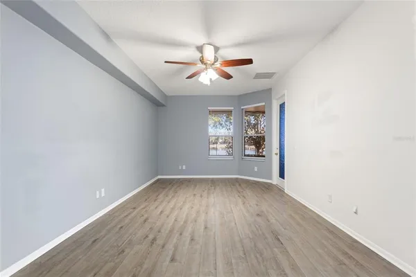 wooden floor in an empty room with a window